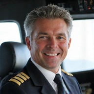 Portrait of David Miller, an experienced male pilot in a cockpit.